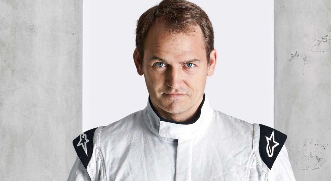 Ben Collins in a white racing suit